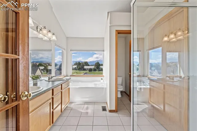 a large white kitchen with a large window
