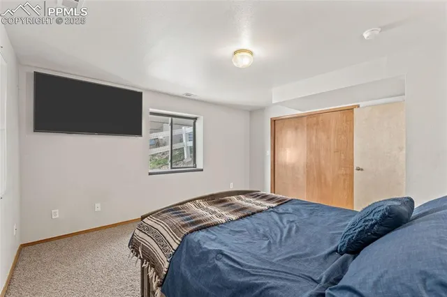 a bedroom with a large bed and a flat screen tv