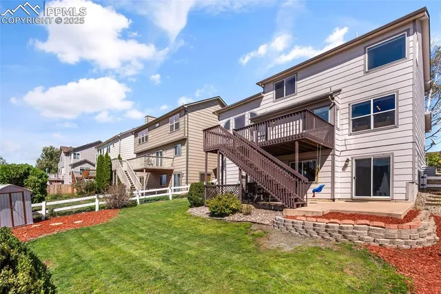 a view of a house with backyard and porch