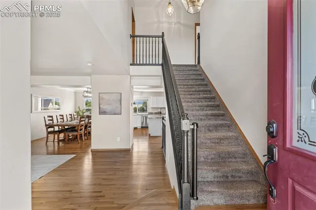 a view of entryway and hall with wooden floor