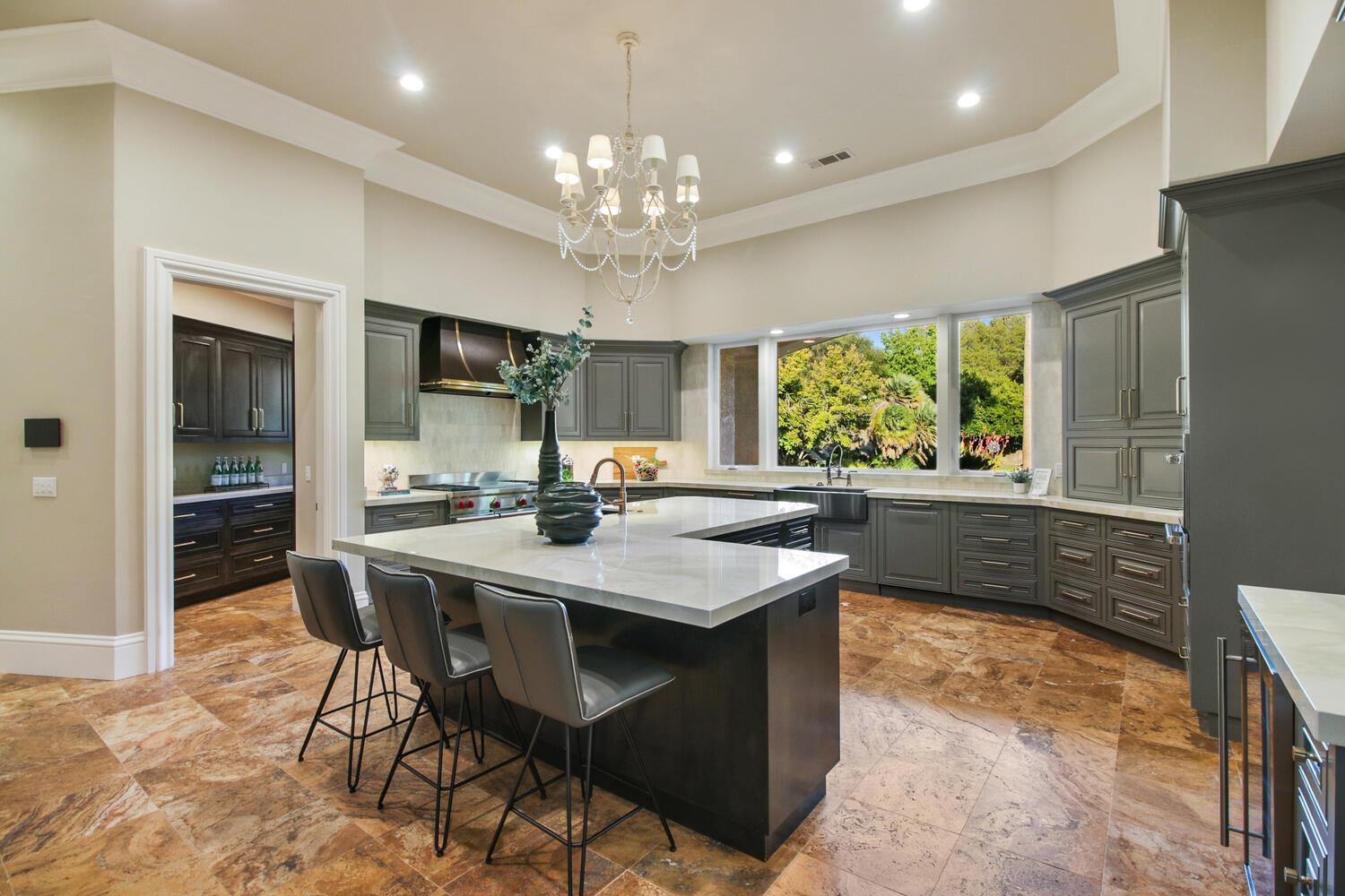 5001 Auburn Folsom Road Loomis, CA 95650 - Photo 32 of 99 a view of a dining room with furniture a chandelier and wooden floor