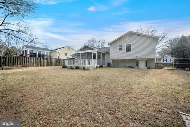 a front view of a house with a yard covered in snow