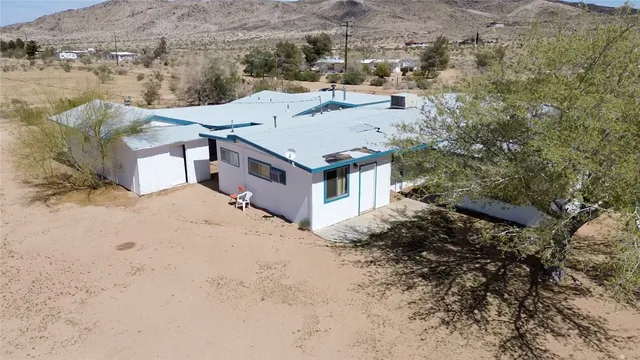 an aerial view of a house with a yard covered with snow