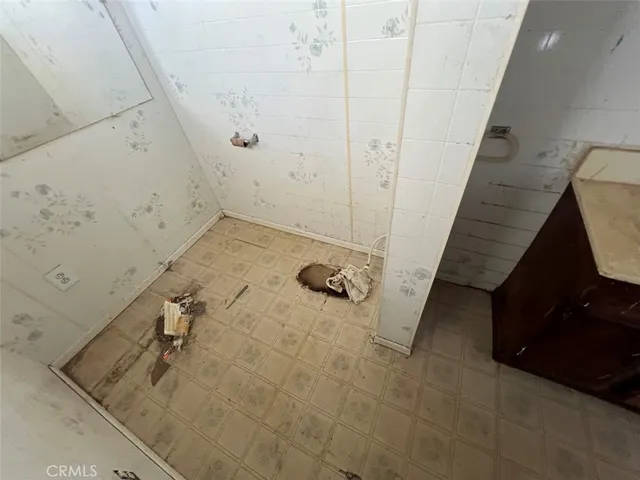 a bathroom with a sink mirror and a shower