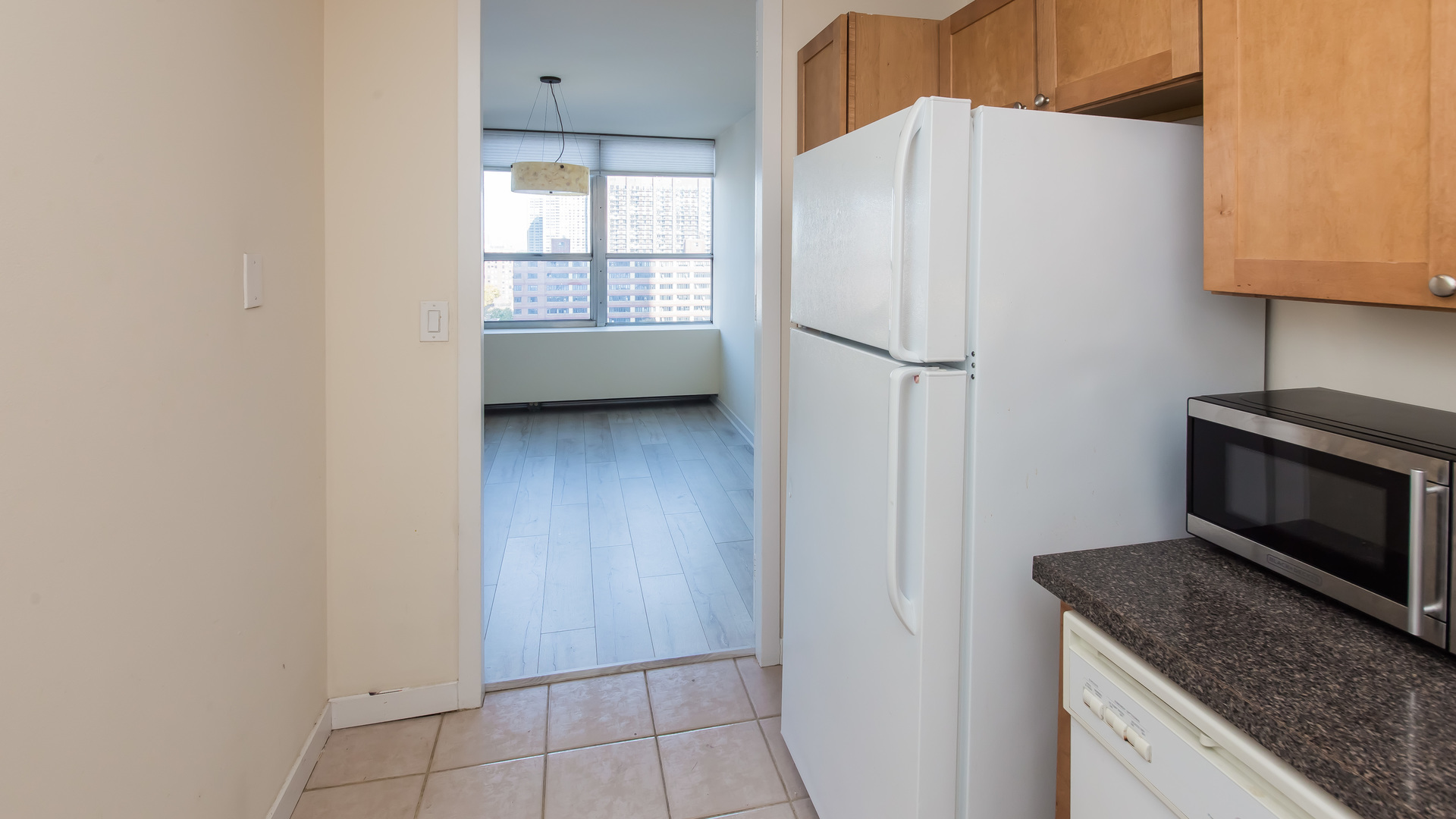655 West Irving Park Road, Unit 1014 Chicago, IL 60613 - Photo 11 of 23 a kitchen with a refrigerator and a stove