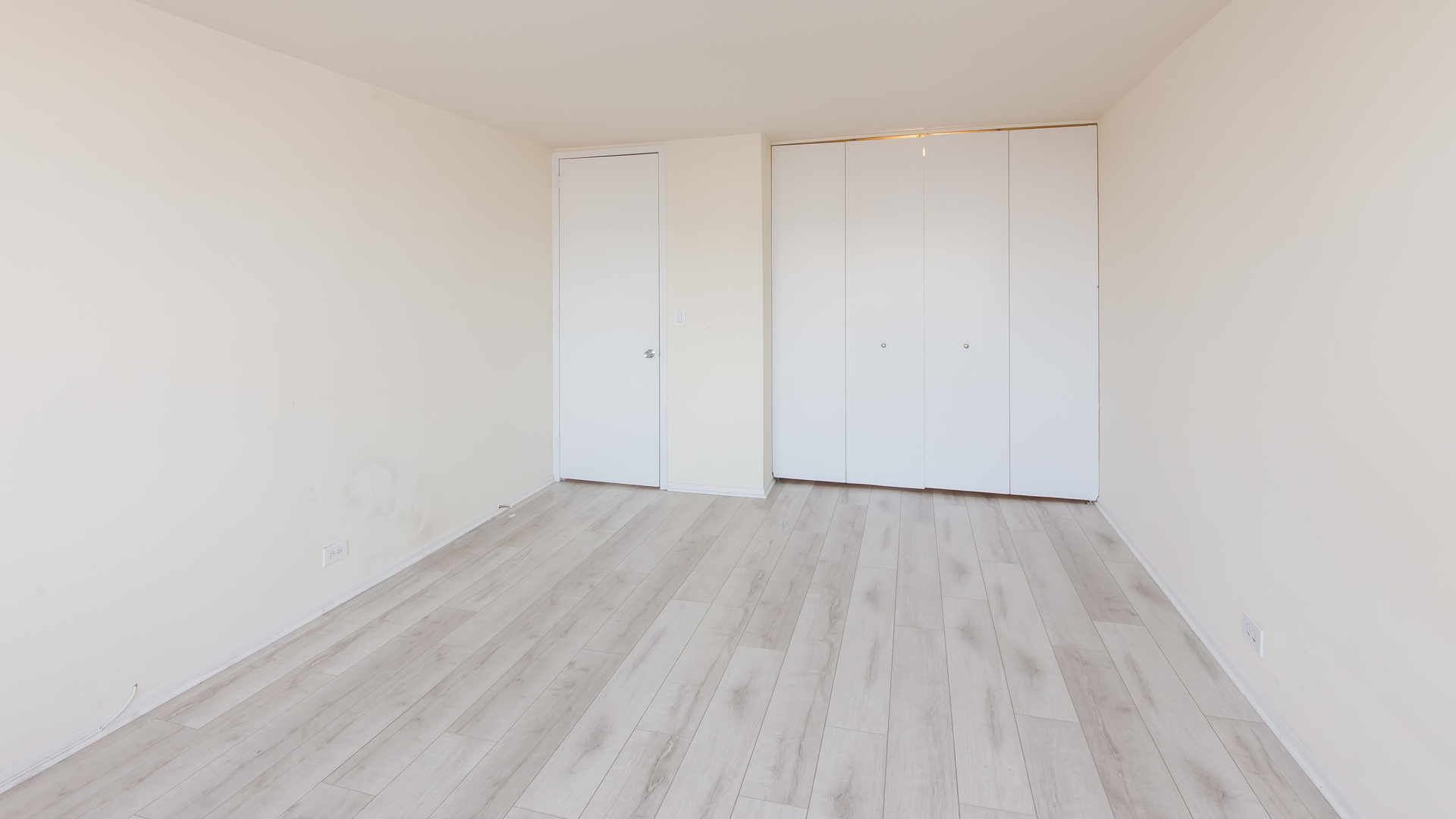 655 West Irving Park Road, Unit 1014 Chicago, IL 60613 - Photo 13 of 23 a view of an empty room with wooden floor