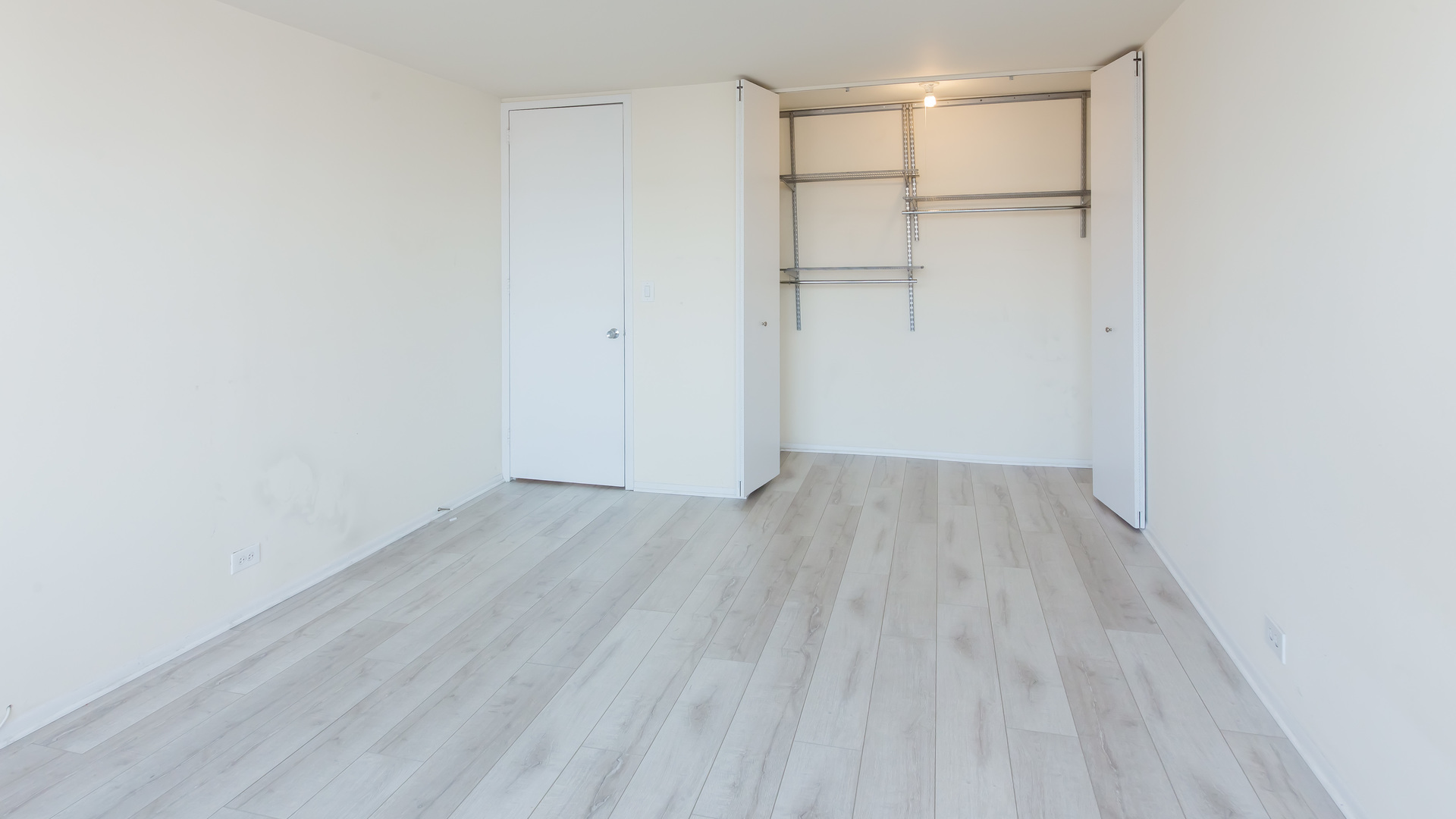 655 West Irving Park Road, Unit 1014 Chicago, IL 60613 - Photo 14 of 23 a view of a room with wooden floor
