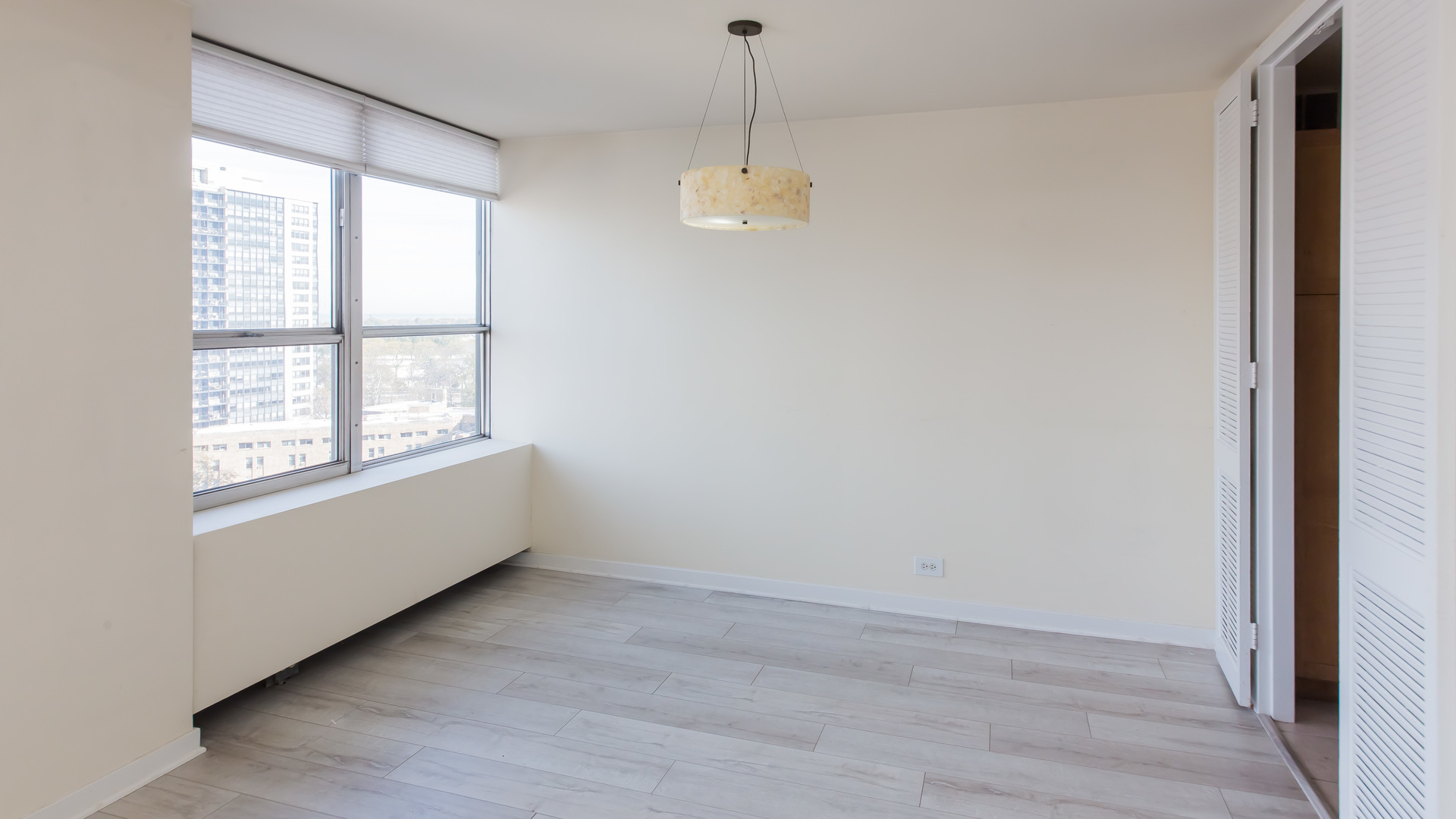 655 West Irving Park Road, Unit 1014 Chicago, IL 60613 - Photo 6 of 23 a view of an empty room with a window