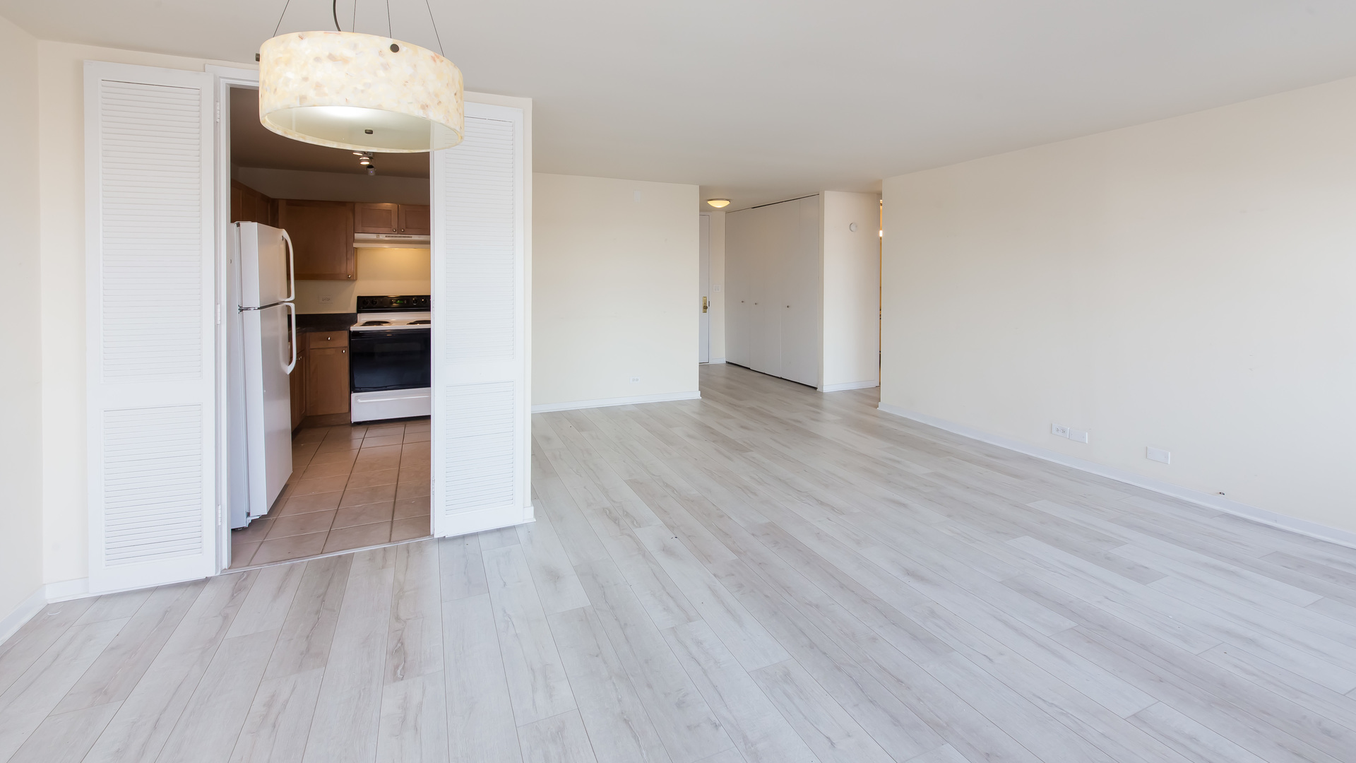 655 West Irving Park Road, Unit 1014 Chicago, IL 60613 - Photo 8 of 23 a view of a hallway with wooden floor and a living room