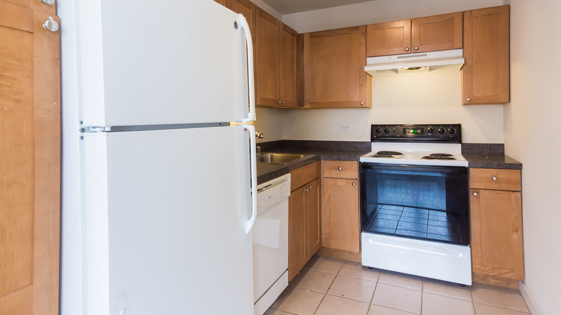 655 West Irving Park Road, Unit 1014 Chicago, IL 60613 - Photo 9 of 23 a kitchen with a refrigerator and a stove