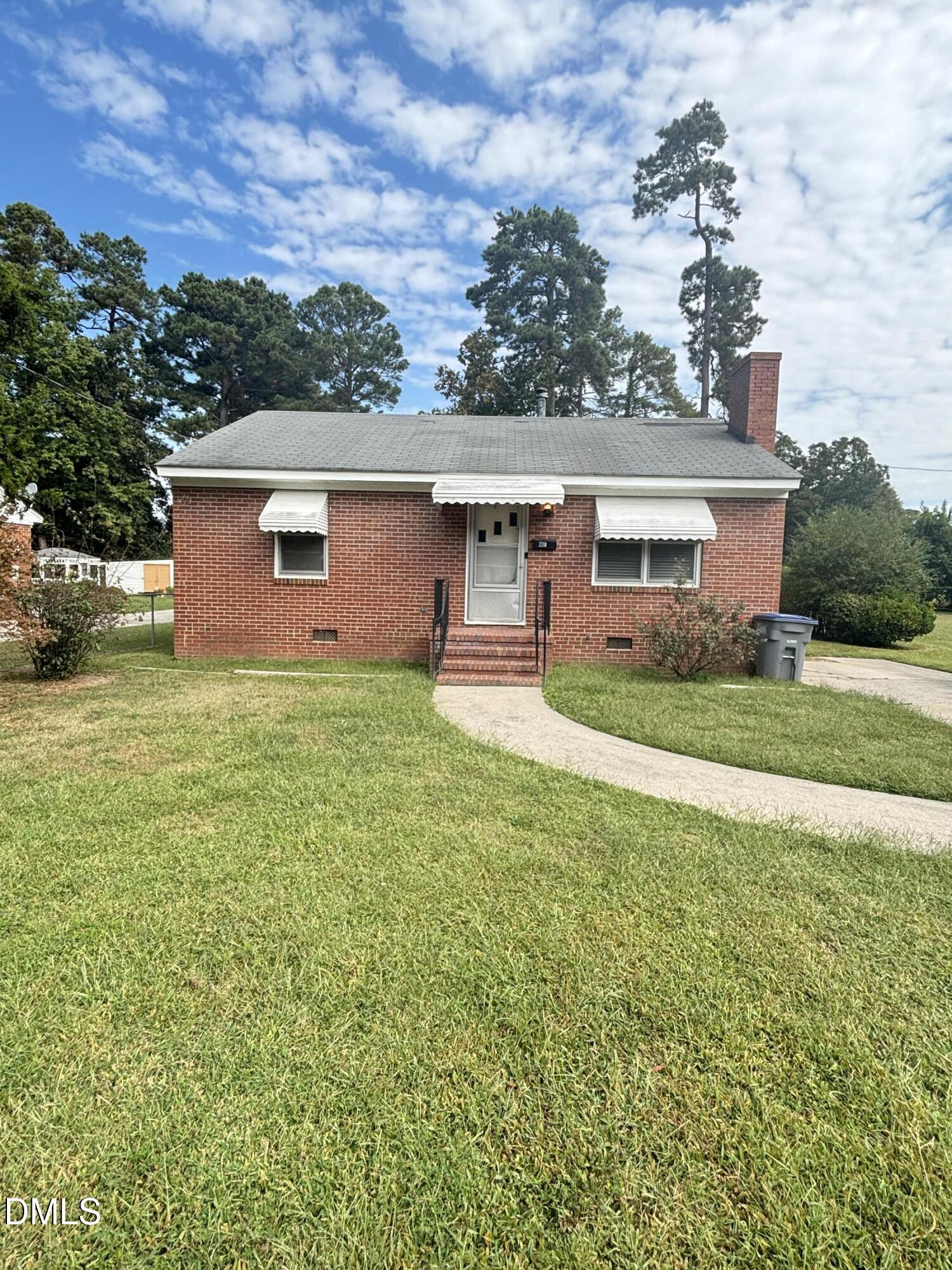 a front view of house with yard and green space