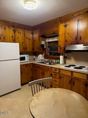 a kitchen with a refrigerator sink and stove
