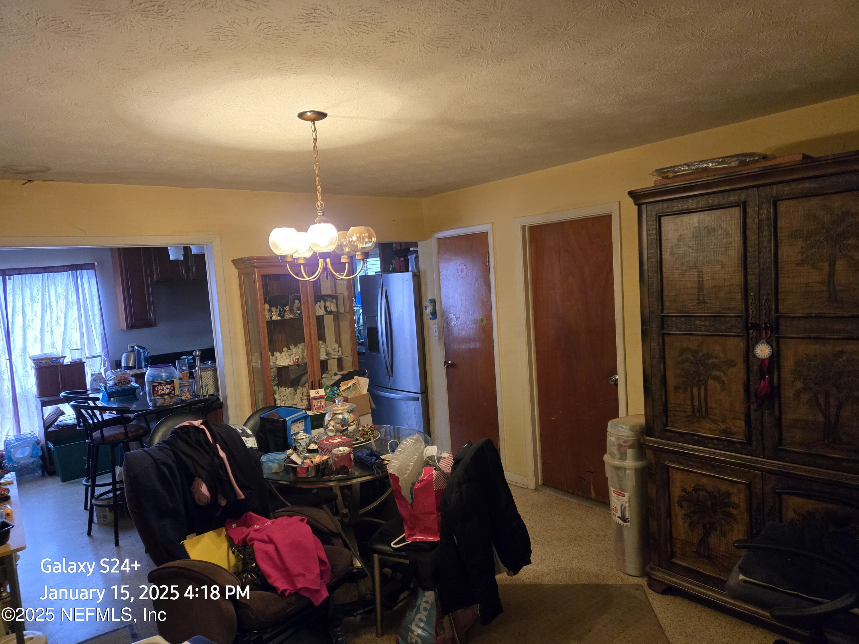 54 Spring Street St. Augustine, FL 32084 - Photo 11 of 31 a living room with furniture and a chandelier