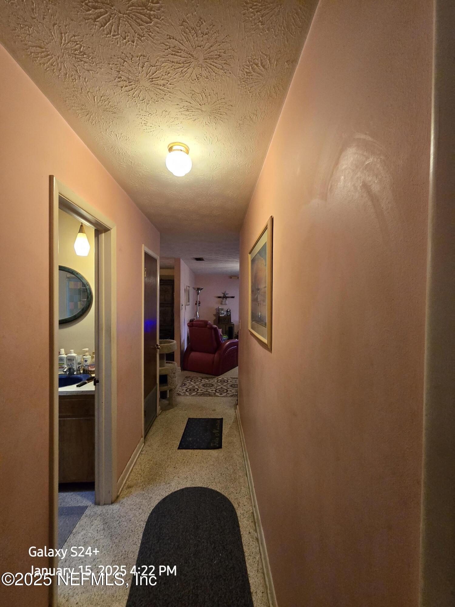 54 Spring Street St. Augustine, FL 32084 - Photo 23 of 31 a view of a hallway to a livingroom and a stove