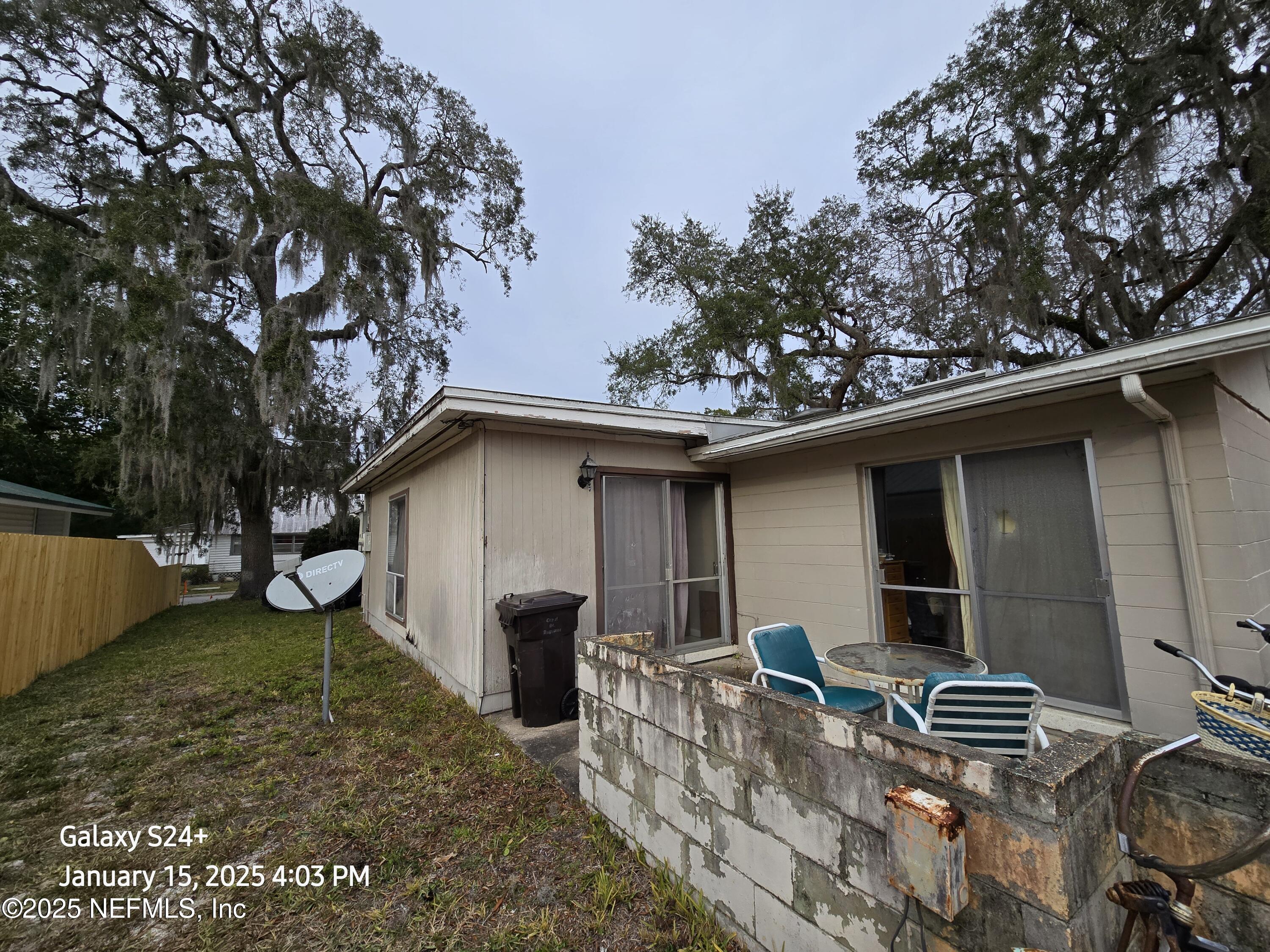54 Spring Street St. Augustine, FL 32084 - Photo 5 of 31 a backyard of a house with barbeque oven and outdoor seating