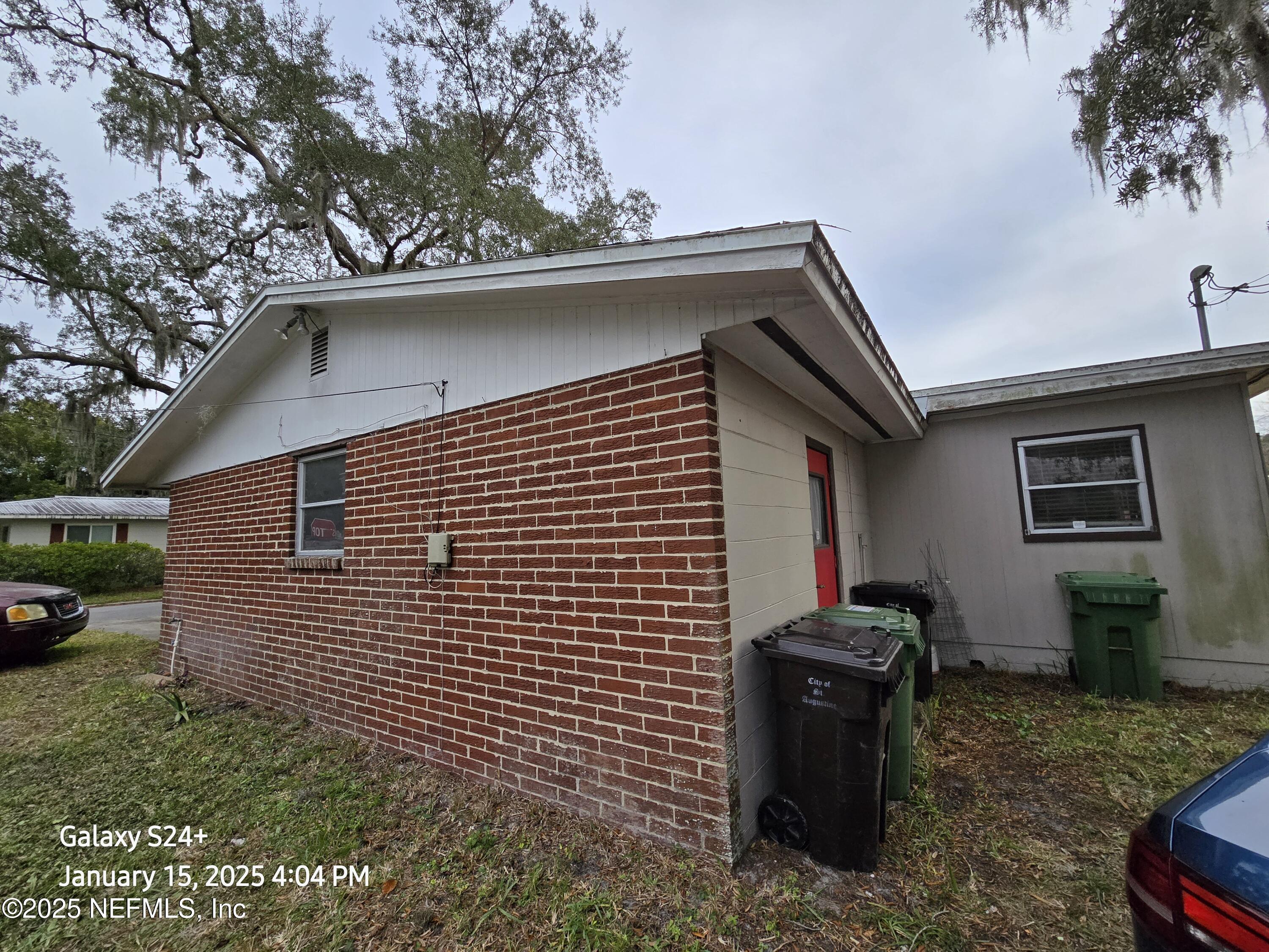 54 Spring Street St. Augustine, FL 32084 - Photo 8 of 31 a side view of a house with a yard