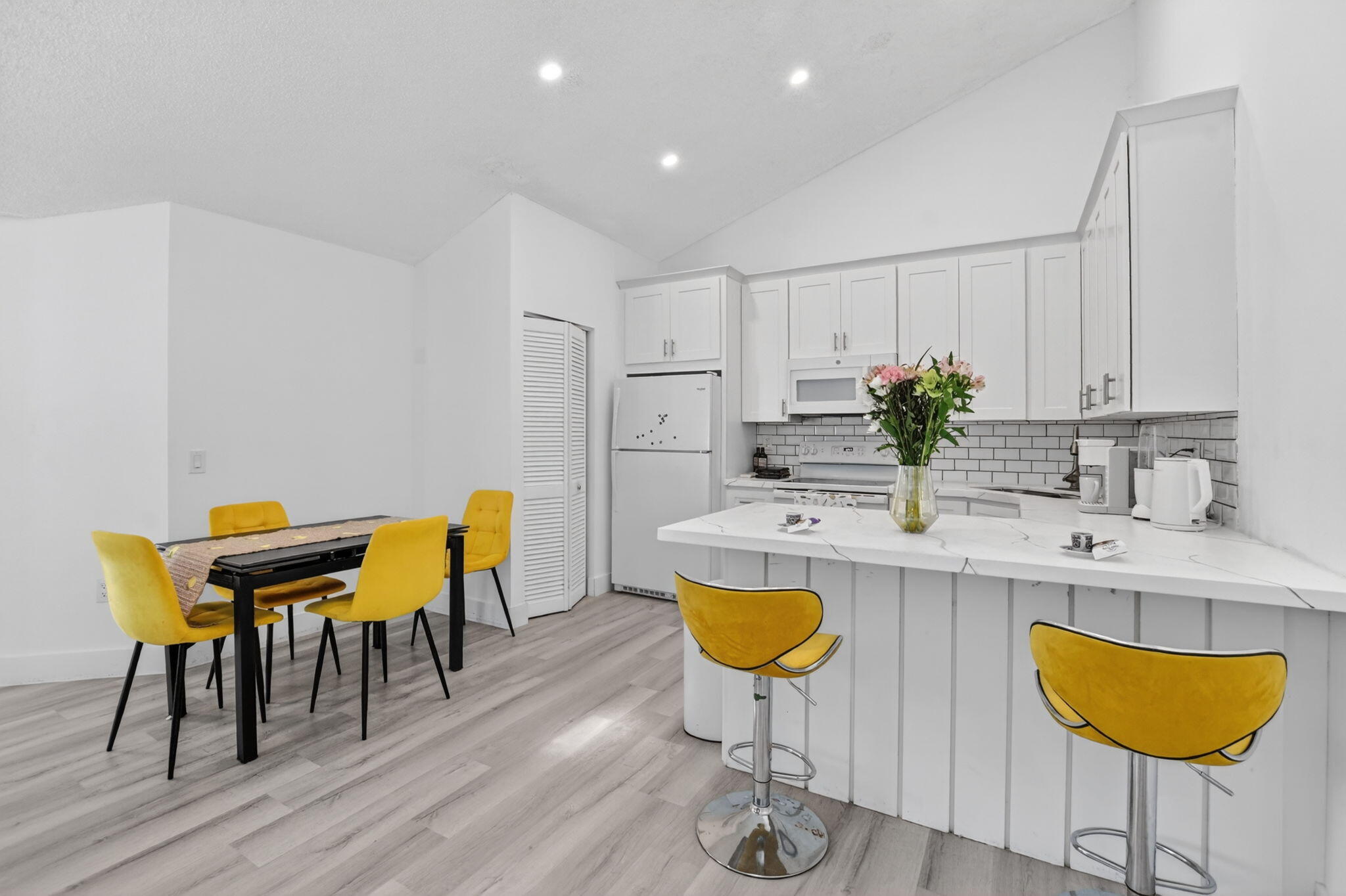 9903 Boca Gardens Trail Boca Raton, FL 33496 - Photo 15 of 37 a kitchen with a dining table chairs and sink