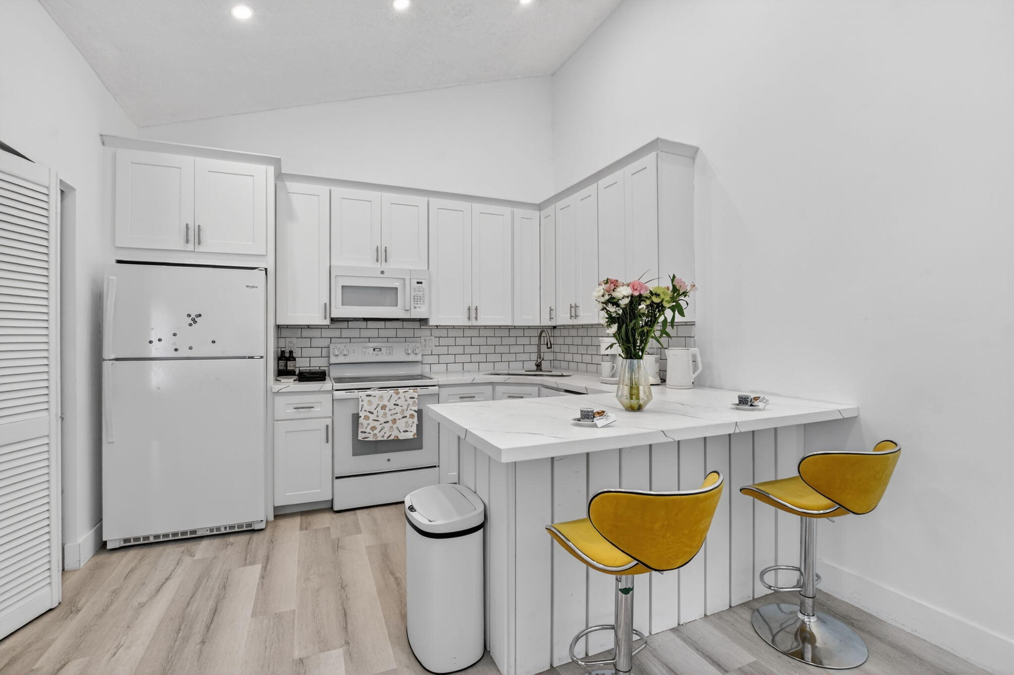 9903 Boca Gardens Trail Boca Raton, FL 33496 - Photo 16 of 37 a kitchen with stainless steel appliances granite countertop a dining table chairs and white cabinets