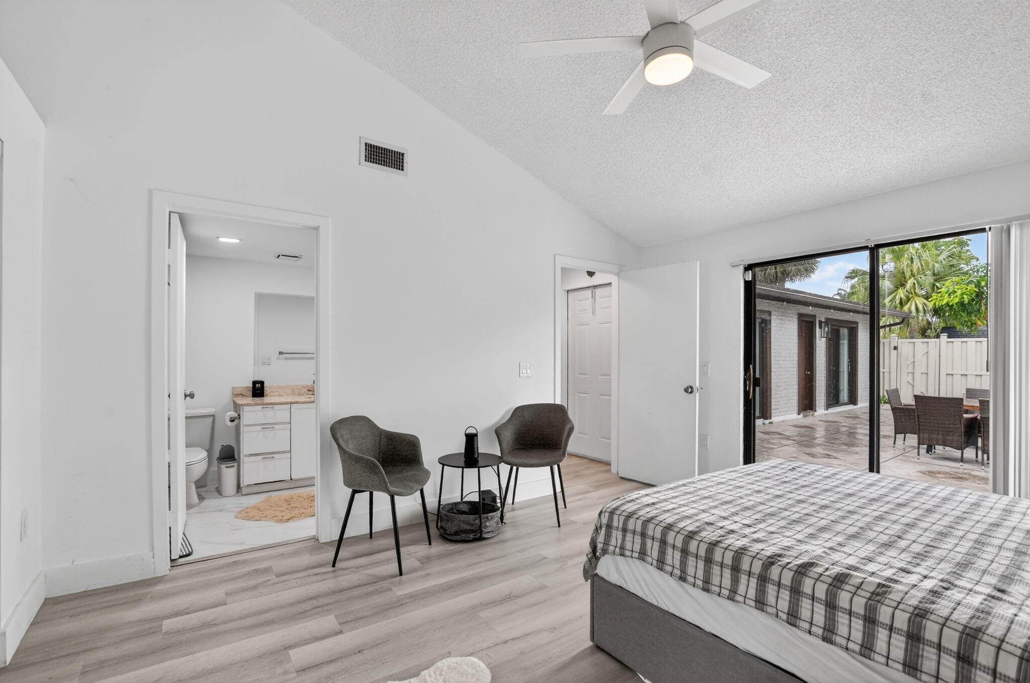 9903 Boca Gardens Trail Boca Raton, FL 33496 - Photo 20 of 37 a bedroom with a bed and a chair