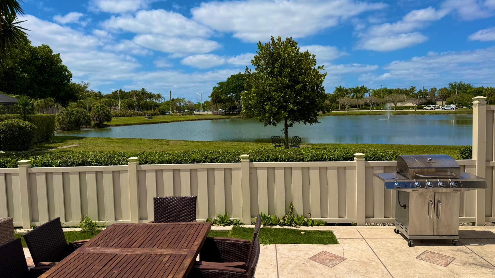 9903 Boca Gardens Trail Boca Raton, FL 33496 - Photo 2 of 37 a view of a wooden deck with lake view