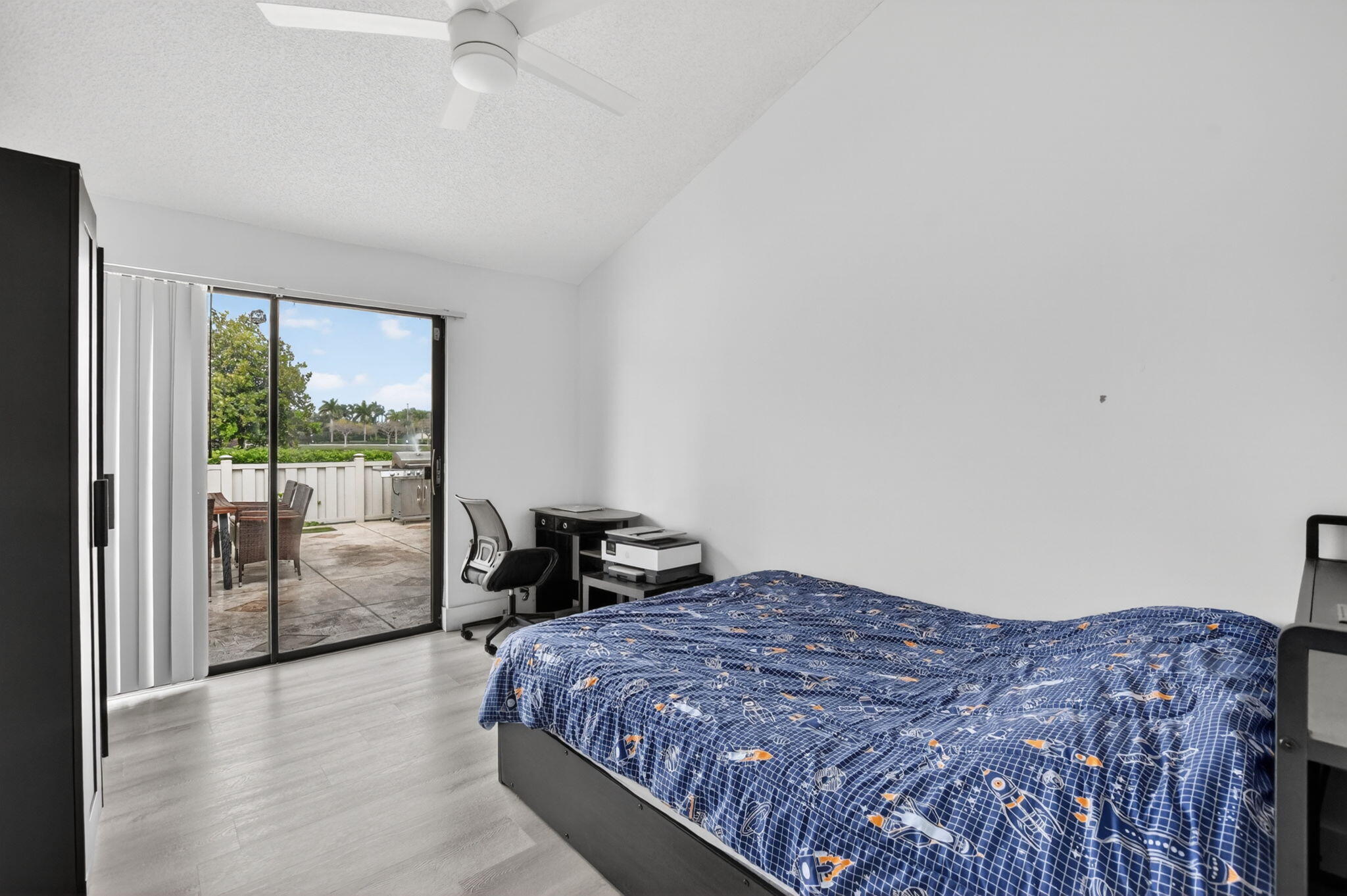 9903 Boca Gardens Trail Boca Raton, FL 33496 - Photo 23 of 37 a bedroom with a bed and glass door