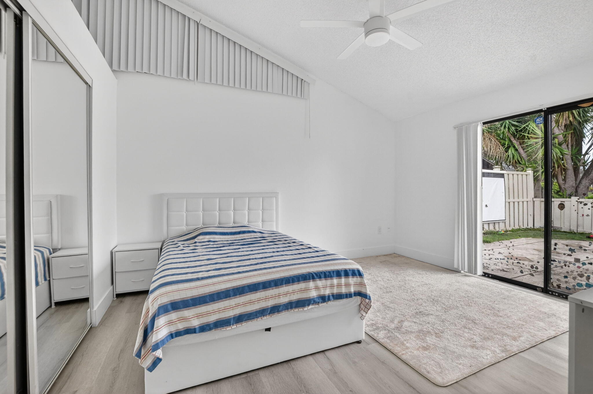 9903 Boca Gardens Trail Boca Raton, FL 33496 - Photo 25 of 37 a bedroom with a bed and large window with balcony view