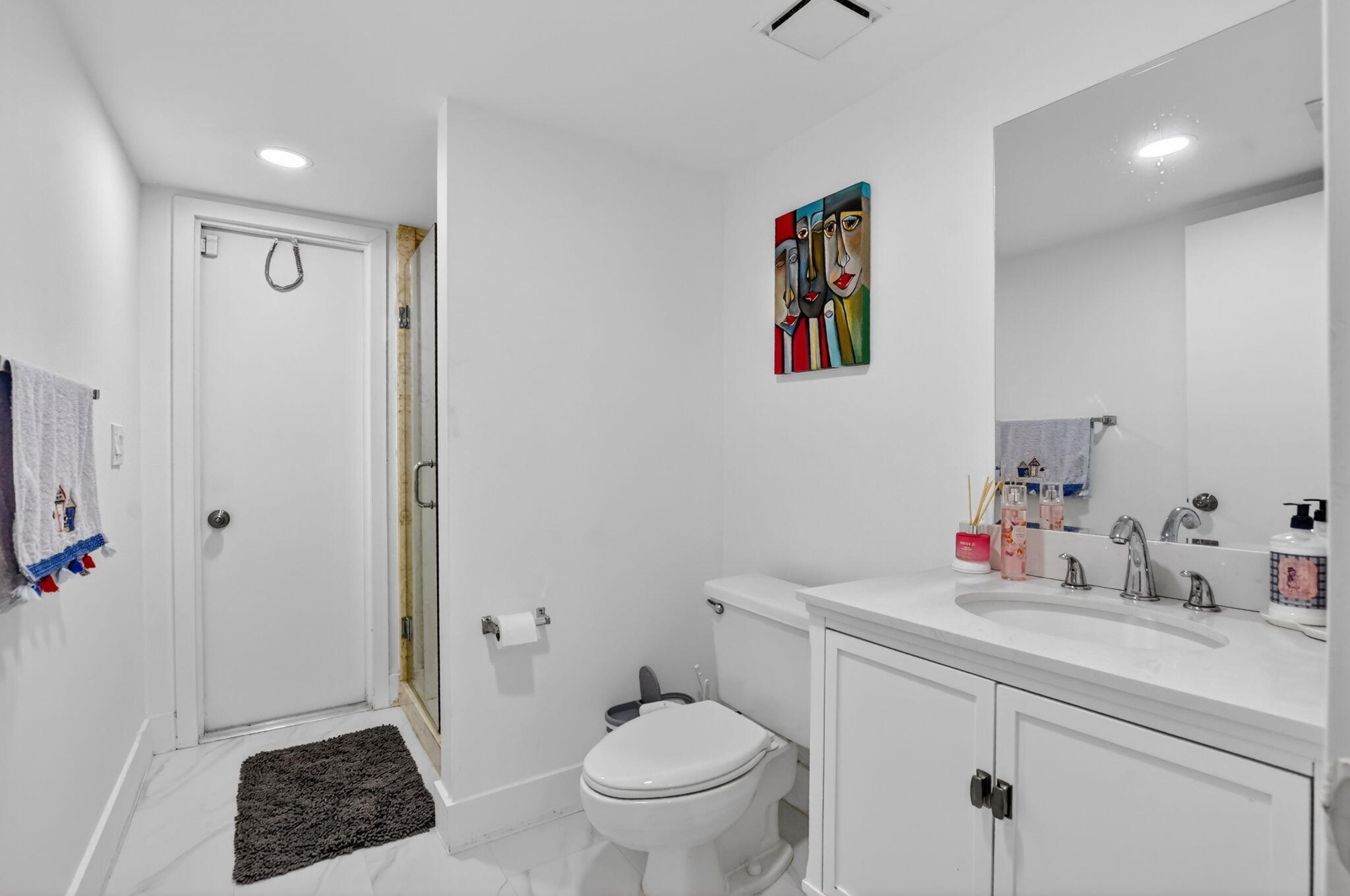 9903 Boca Gardens Trail Boca Raton, FL 33496 - Photo 28 of 37 a bathroom with a toilet a sink and a mirror