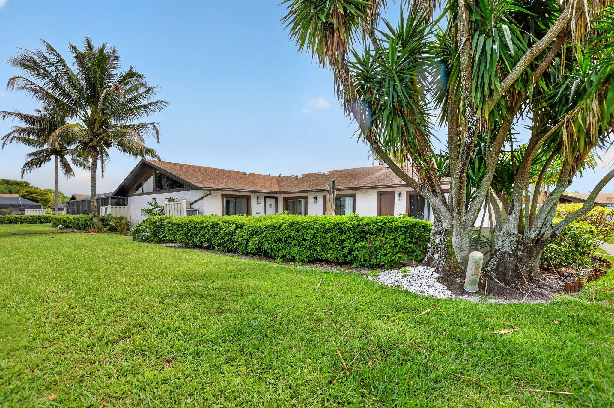 9903 Boca Gardens Trail Boca Raton, FL 33496 - Photo 3 of 37 a front view of house with yard and green space