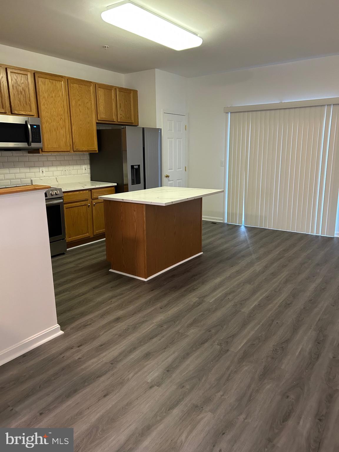 662 Luthardt Road Middle River, MD 21220 - Photo 20 of 52 a kitchen with wooden floors and wooden cabinets