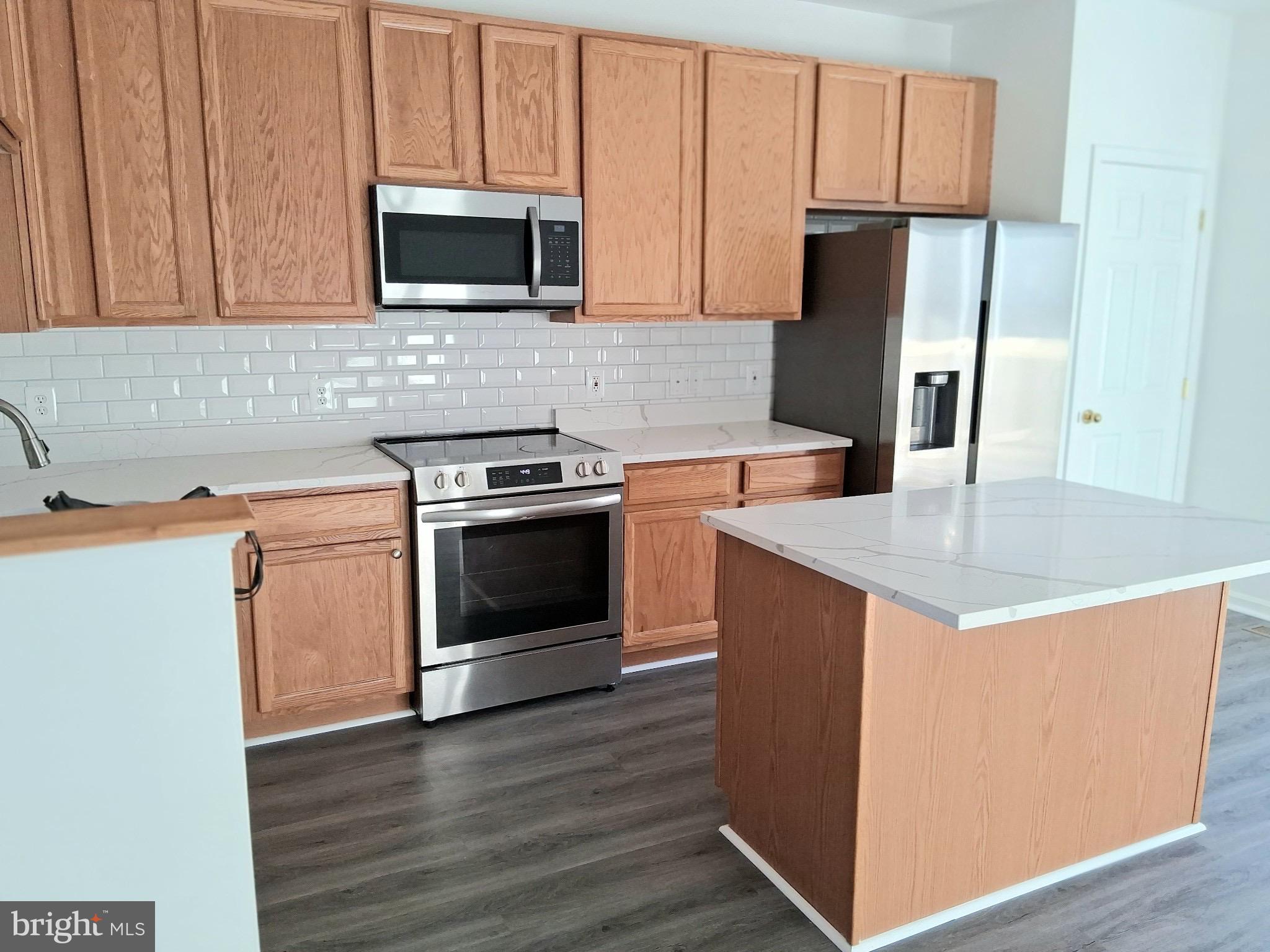 662 Luthardt Road Middle River, MD 21220 - Photo 48 of 52 a kitchen with a stove microwave and refrigerator