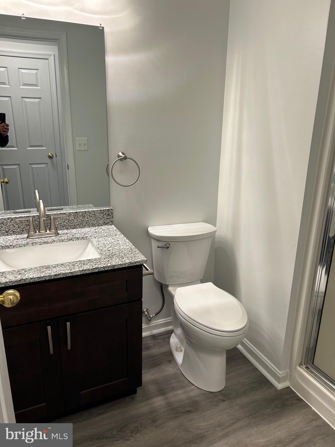 662 Luthardt Road Middle River, MD 21220 - Photo 7 of 52 a bathroom with a granite countertop toilet a sink and a mirror
