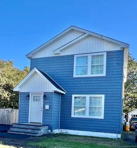 a view of a house with wooden fence