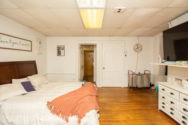 a bedroom with a bed and flat screen tv