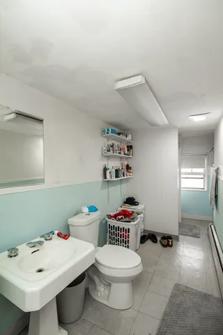 a bathroom with a sink toilet and a shower