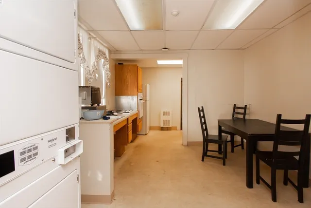 a kitchen that has a table and chairs in it