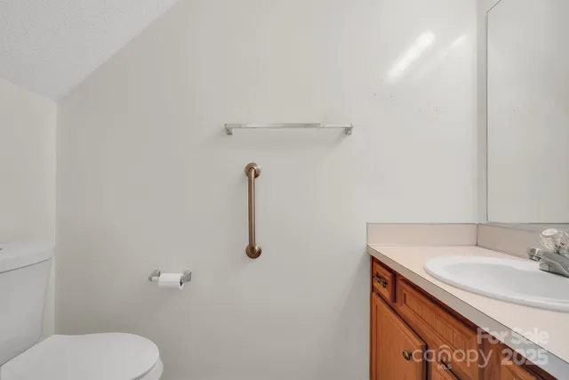 a bathroom with a sink toilet and a mirror