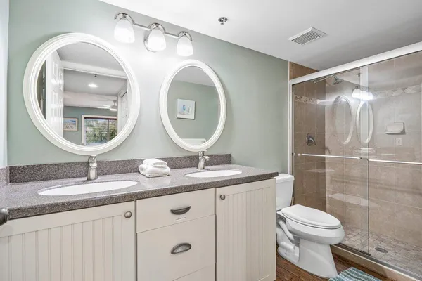 a white toilet sitting next to a bathroom sink