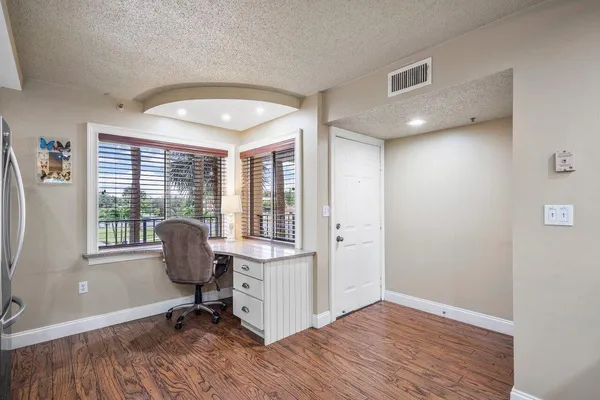 a view of a dining room with furniture window and wooden floor
