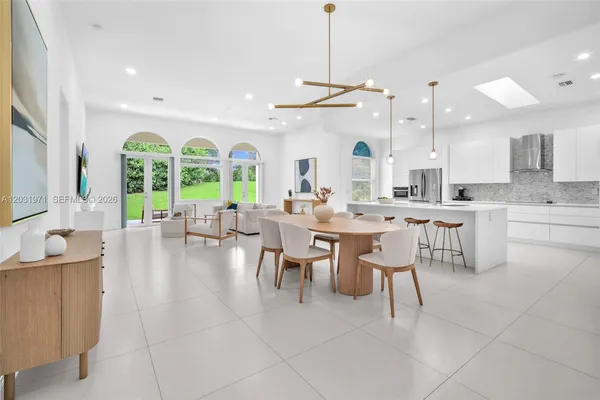 a large kitchen with a table and chairs
