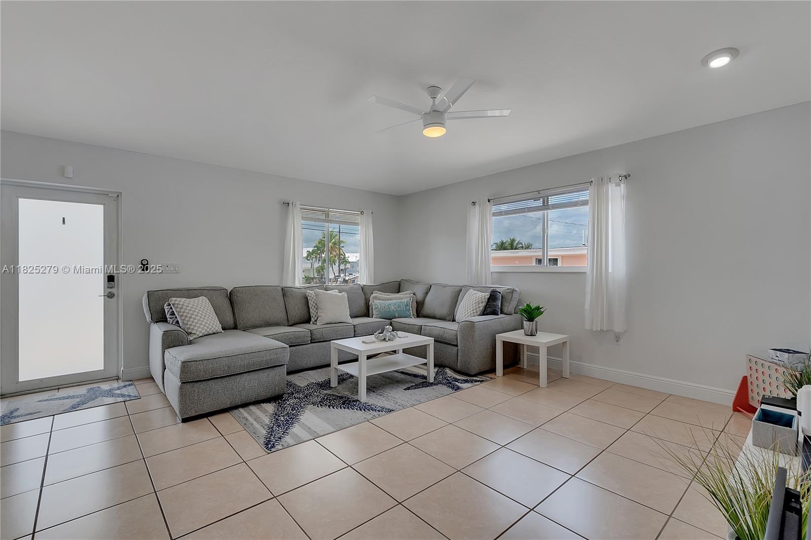 939 Plantation Road Key Largo, FL 33037 - Photo 11 of 41 a living room with furniture and a view of bathroom