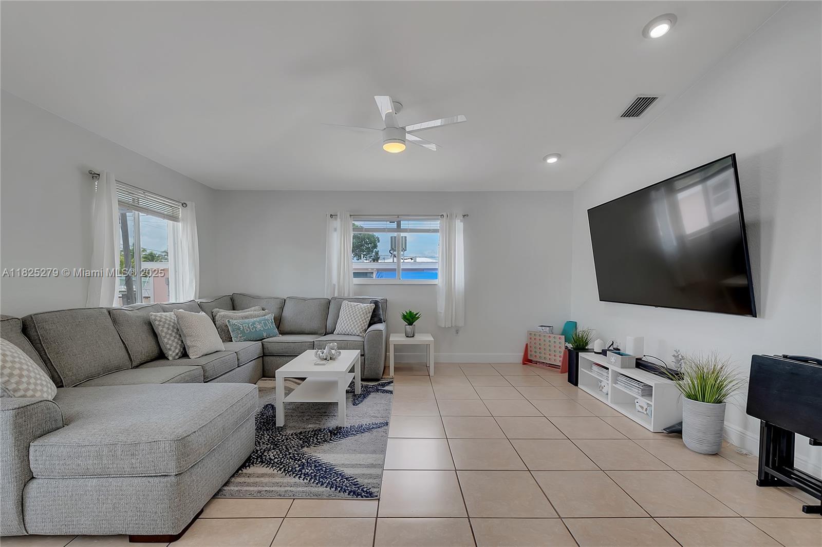 939 Plantation Road Key Largo, FL 33037 - Photo 12 of 41 a living room with furniture and a flat screen tv
