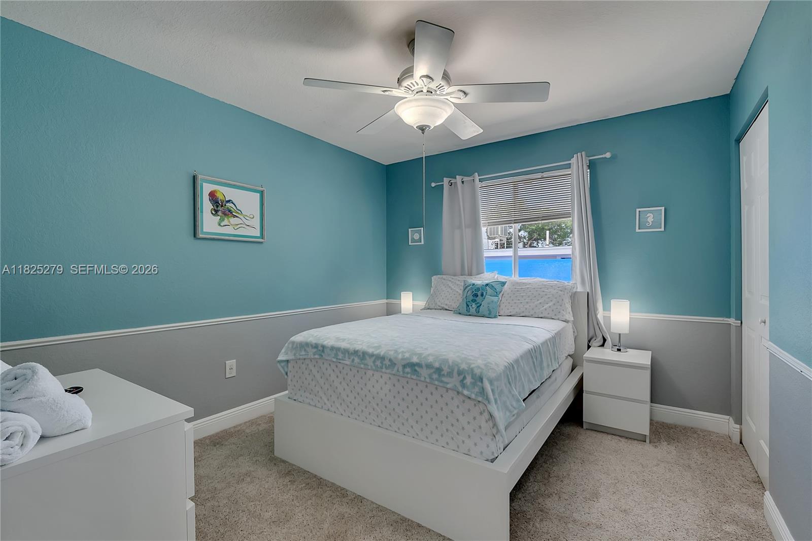 939 Plantation Road Key Largo, FL 33037 - Photo 16 of 40 a bedroom with a bed and a chandelier