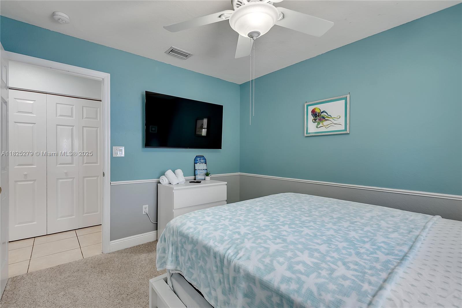 939 Plantation Road Key Largo, FL 33037 - Photo 18 of 41 a bedroom with a bed and a flat screen tv