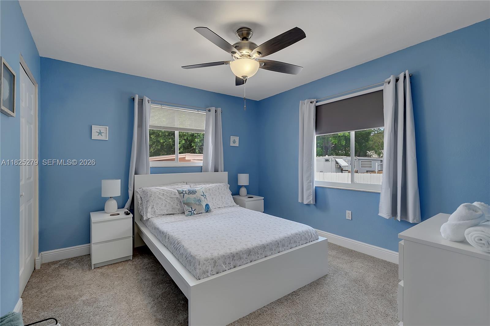 939 Plantation Road Key Largo, FL 33037 - Photo 19 of 40 a bedroom with a large bed and a large window