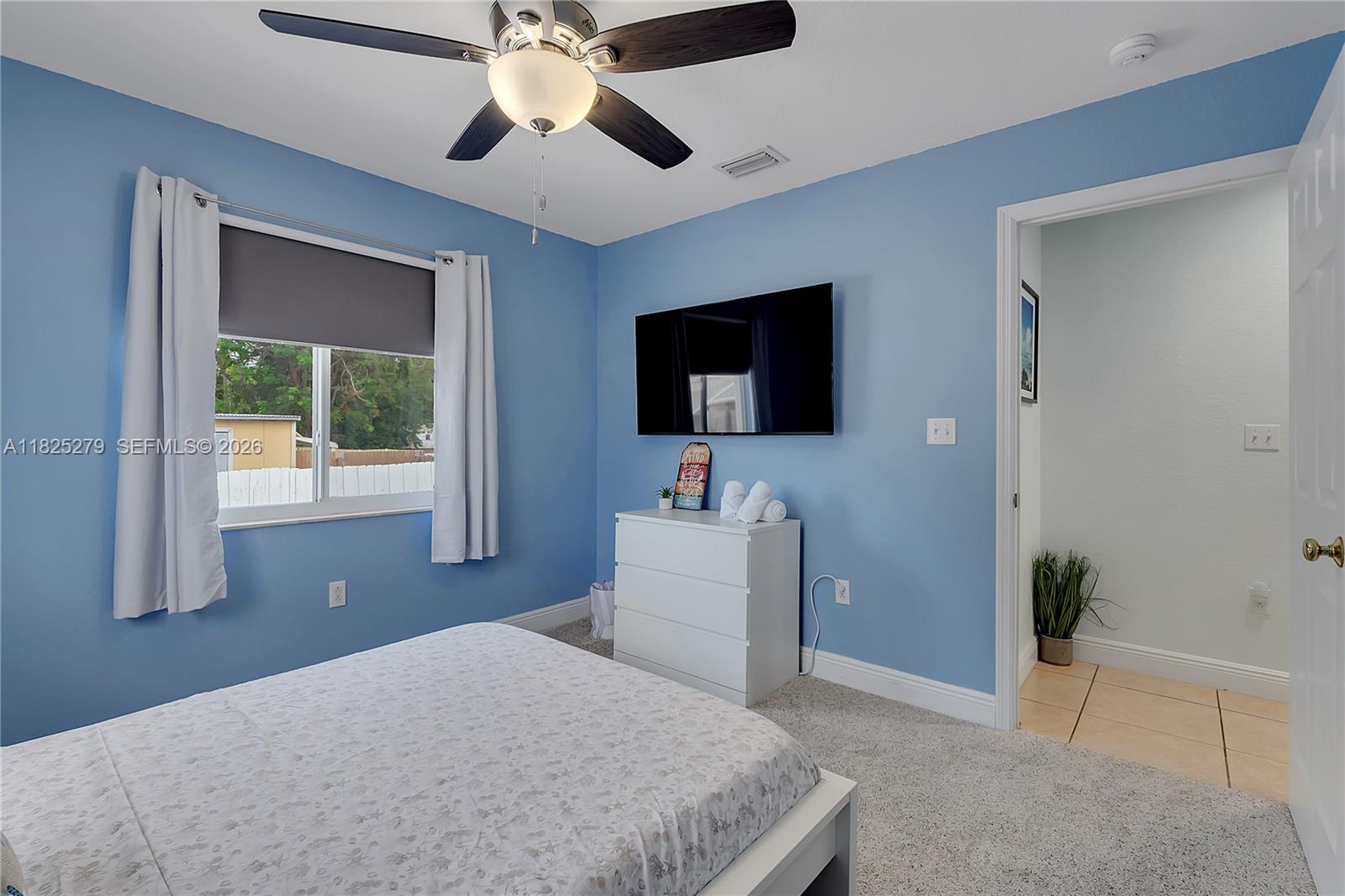 939 Plantation Road Key Largo, FL 33037 - Photo 20 of 40 a bedroom with a bed and a flat screen tv