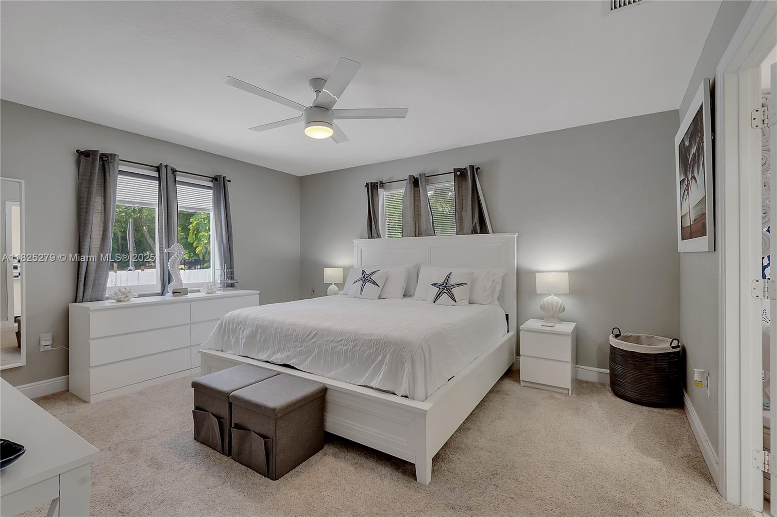 939 Plantation Road Key Largo, FL 33037 - Photo 23 of 41 a spacious bedroom with a bed and a large window