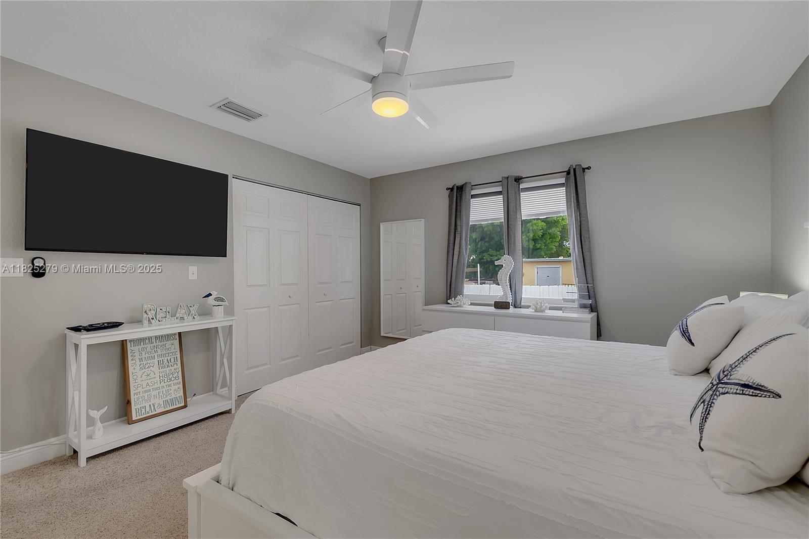 939 Plantation Road Key Largo, FL 33037 - Photo 24 of 41 a bedroom with a bed and a flat screen tv