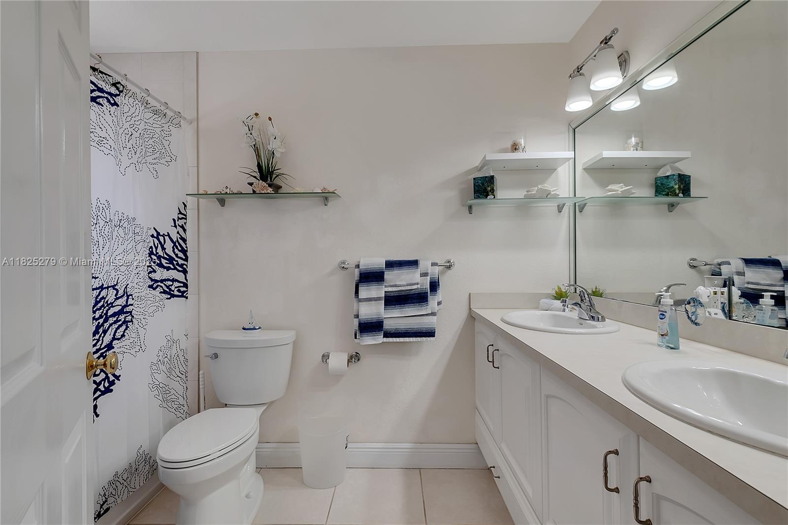 939 Plantation Road Key Largo, FL 33037 - Photo 25 of 41 a bathroom with a sink toilet vanity and shower