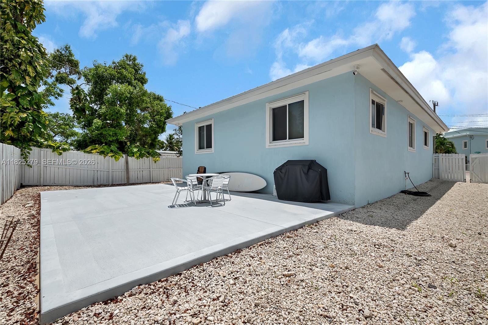 939 Plantation Road Key Largo, FL 33037 - Photo 7 of 40 a view of backyard with barbeque grill and wooden fence