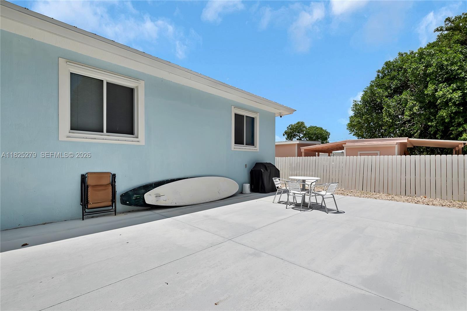 939 Plantation Road Key Largo, FL 33037 - Photo 8 of 40 a view of a chairs and table in the back yard of the house